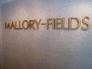 Mallory-Fields Interior Design logo on the wall of the showroom