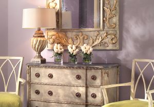Entryway featuring high end home furnishings including luxury fabric chairs and armoire with a mirror and accessories